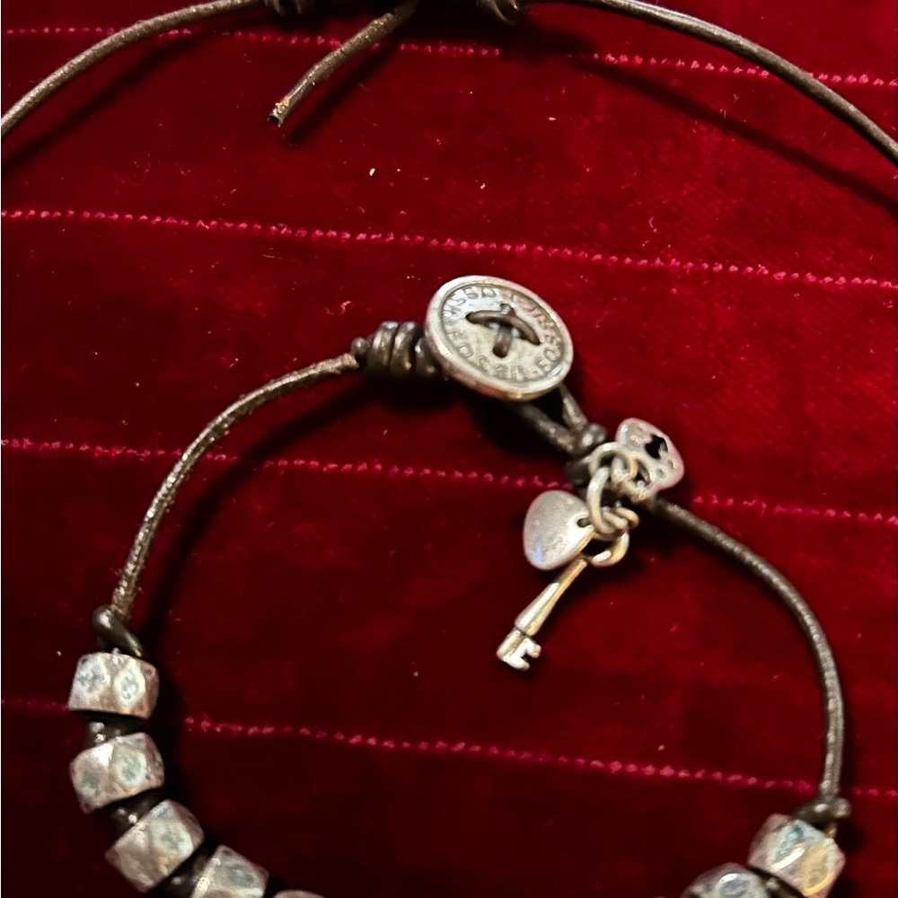 Silvertone and leather cord necklace & bracelet set.